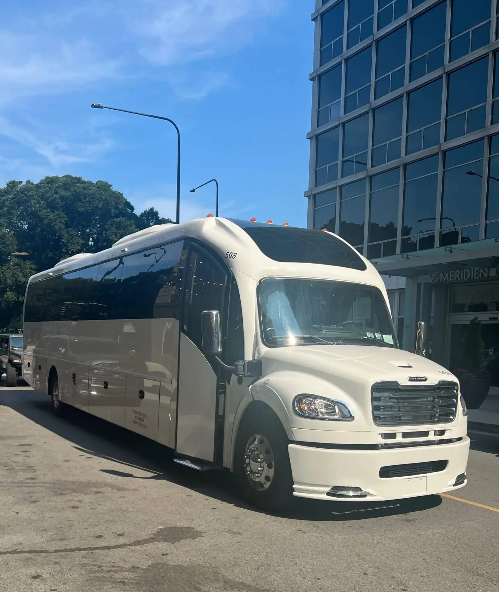 Photo of a white 54-passenger Coach Bus