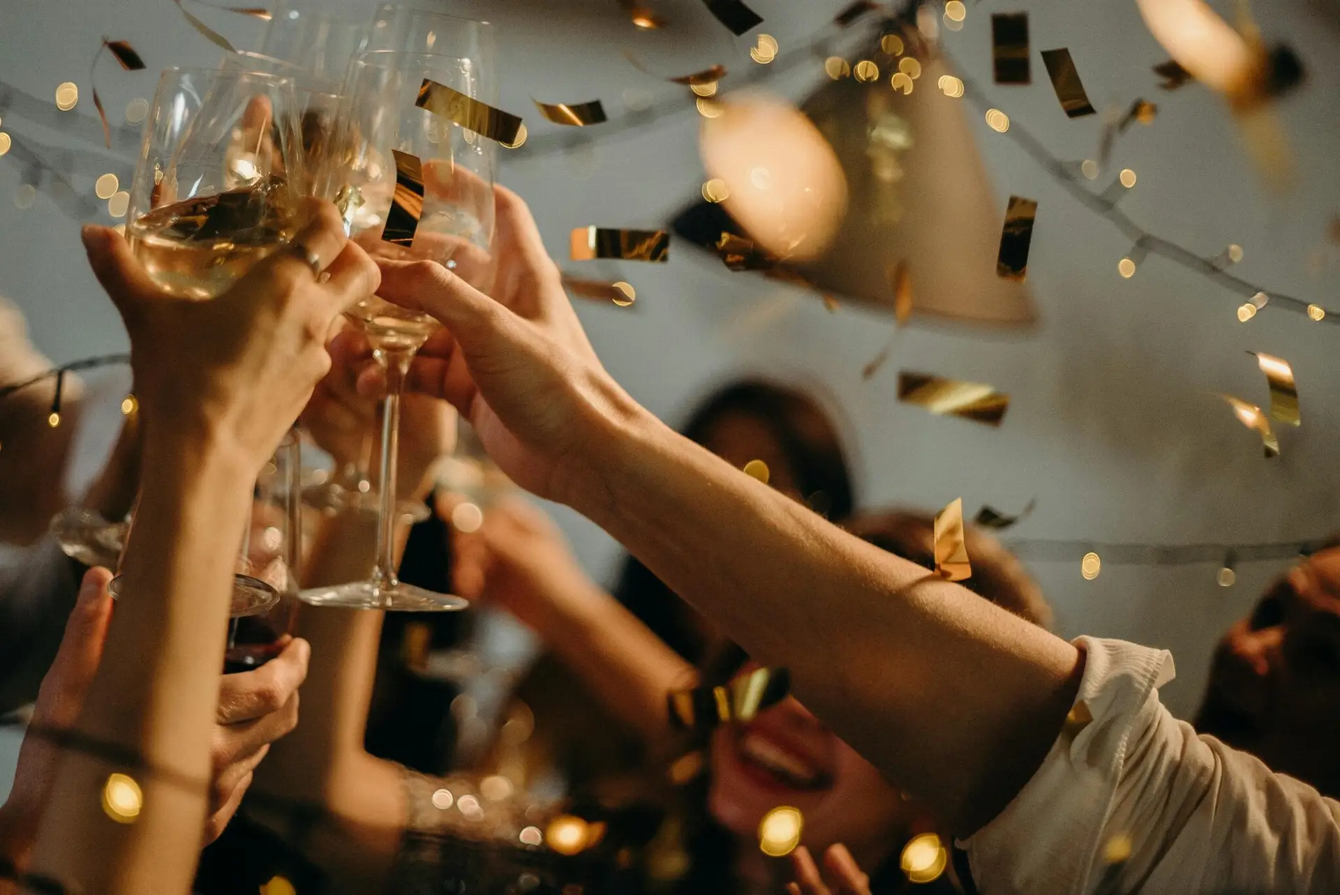 Several friends raise glasses of champagne to celebrate an event.